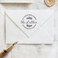 A personalized self inking address stamp, customized with your name and address, stamped on the white envelope, beside it, a wax seal is waiting for sealing the mail.