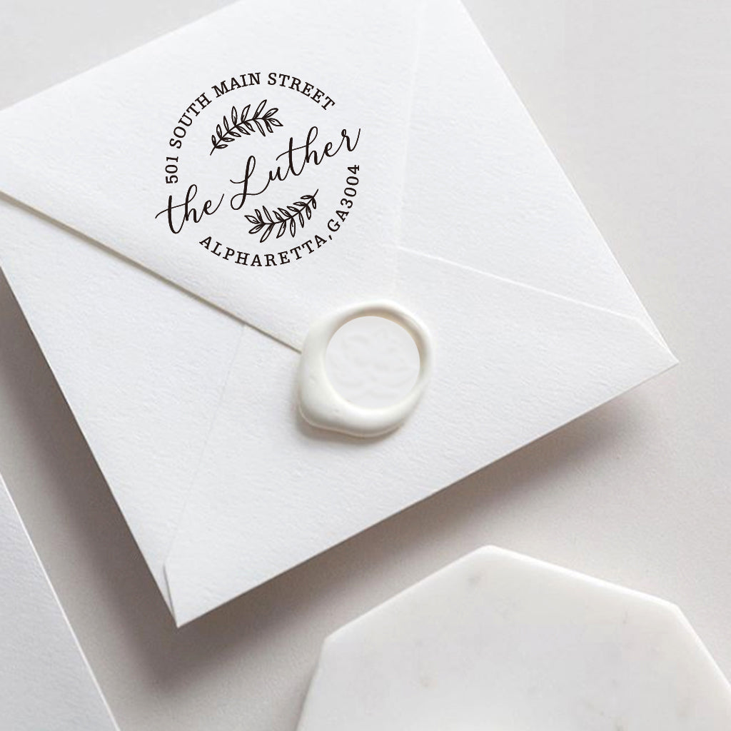 A self inking return address stamp, customized with your name and address, stamped on the white envelop of invitation card, a wax seal sealed the envelope.
