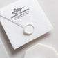 A self inking return address stamp, customized with your name, address and flower, stamped on the white envelop of invitation card, a wax seal sealed the envelope.