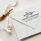 A personalized self inking address stamp, customized with your name, address and flower, stamped on the white envelop, beside it, a ribbon is waiting for packing the gift.