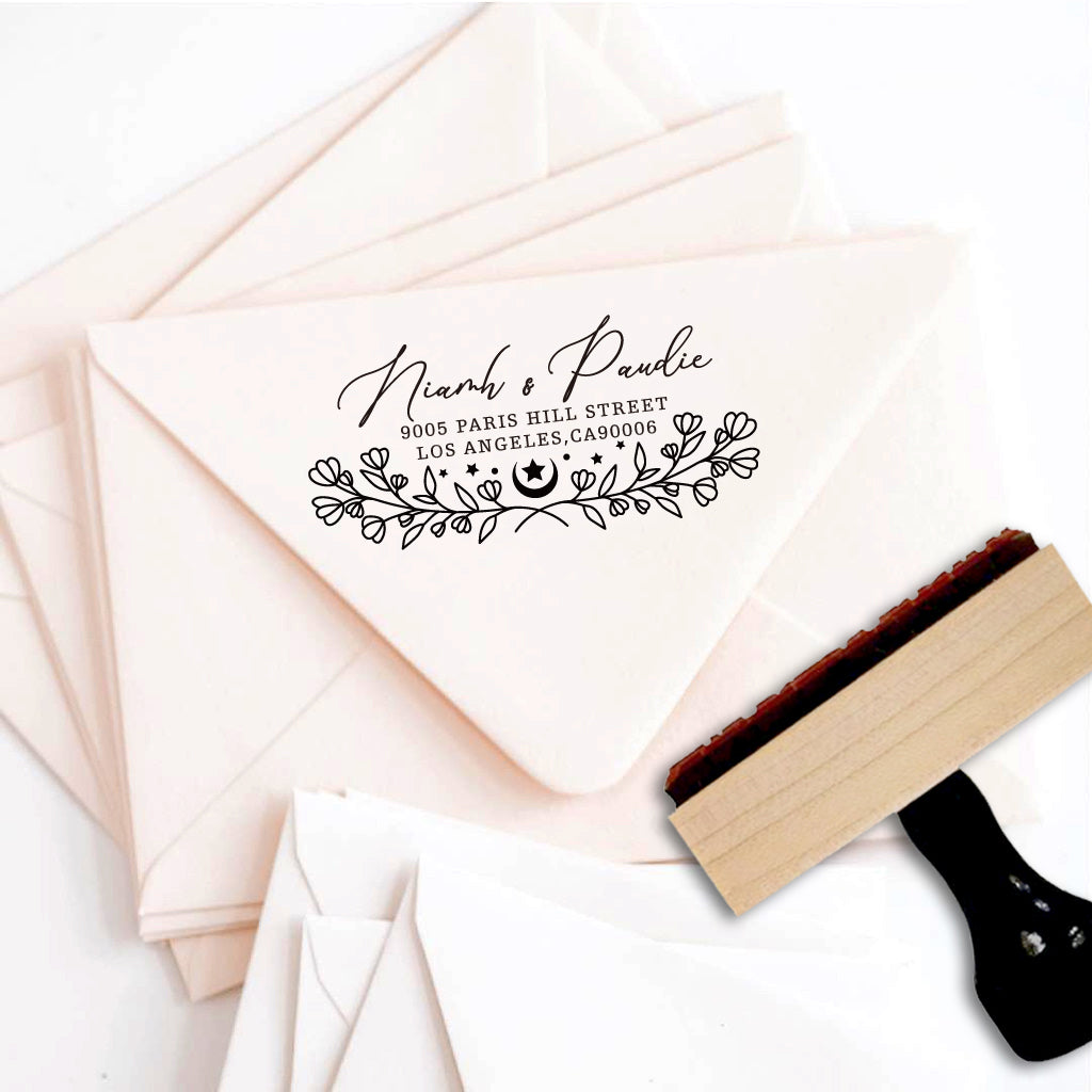A personalized self inking address stamp, customized with your name, address and flower, stamped on the pink envelope.