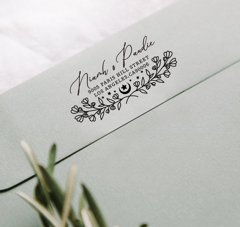 A personalized self inking address stamp, customized with your name, address and flower, stamped on the gray envelope.