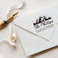 A personalized self inking address stamp, customized with your mountain logo name and address, stamped on the white envelop, beside it, a ribbon is waiting for packing the gift.