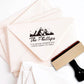 A personalized self inking return address stamp, customized with your mountain logo name and address, stamped on the pink envelope.