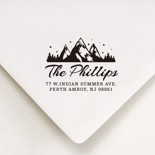 A personalized self inking return address stamp, customized with your mountain logo name and address, stamped on the white envelope.