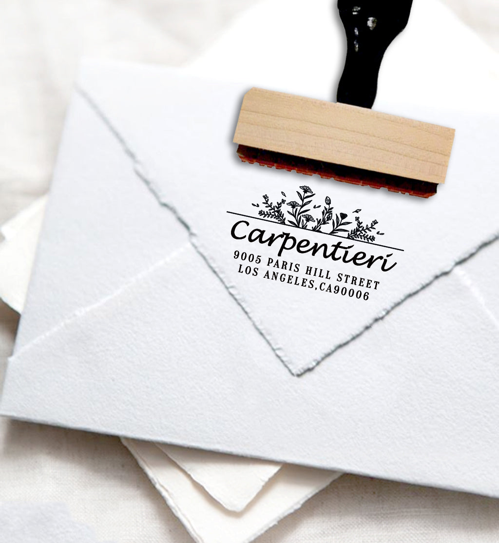 A personalized self inking address stamp, customized with your name, address and flower, stamped on the white envelope.