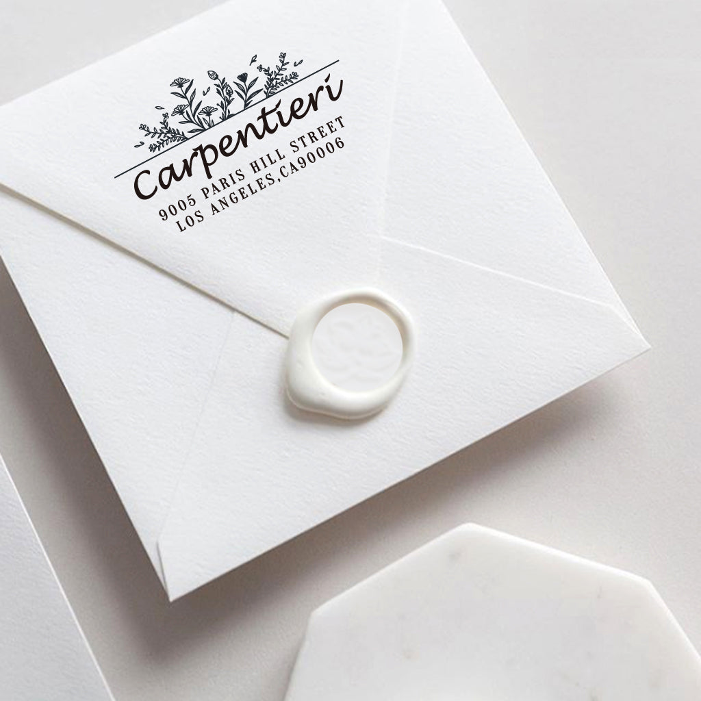 A self inking return address stamp, customized with your name, address and flower, stamped on the white envelop of invitation card, a wax seal sealed the envelope.