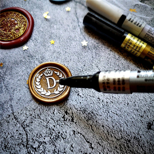 sealing wax pen is coloring the silver color for a wedding wax seal